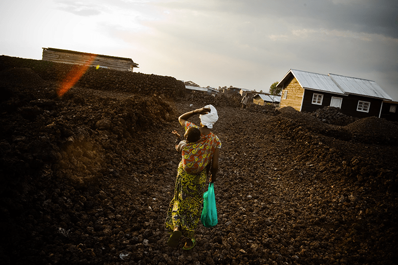 eanine Kahindo, 28, walks through lava rocks in the Majengo neighborhood in Goma, Eastern Democratic Republic of Congo on Saturday December 20, 2008. Photo by photojournalist Olivier Asselin