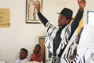 A prayer leader at the Ghihon Synagogue raises his arms in prayer Photo by Chika Oduah