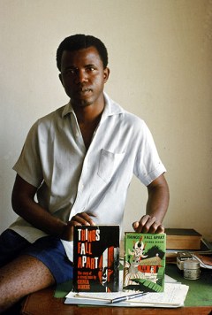 Chinua Achebe in 1960 holding copies of his 1958 novel Things Fall Apart