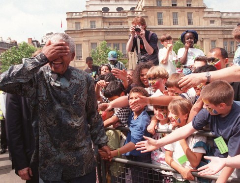 South Africa's President Nelson Mandela walks amongst the vast Trafalgar Square crowd in London Friday July 12 1996. The President later addressed the crowd from the balcony of South Africa House on this, the last leg of his four-day State visit to Britain. (AP PHOTO / DAVE CAULKIN/ WPA POOL)