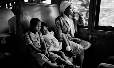 ca. 1986, South Africa --- South African Family Traveling on a Train --- Image by © David Turnley/CORBIS