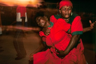 HAITI, CROIX-DES-BOUQUETS. Ceremony dedicated to St. John the Baptist. Two mambos (voodoo priestesses) are in a trance, possessed by the loas (spirits) in October 1995. Photo by Jean-Claude Coutausse