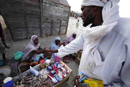 A Mauritanian man buys goods in the Keube slum in the capital Nouakchott in this March 13, 2007 picture. Herding camels or goats out in the sun-blasted dunes of the Sahara, or serving hot mint tea to guests in the richly carpeted villas of Nouakchott, Mauritanian slaves serve their masters and are passed on as family chattels from generation to generation. CREDIT: REUTERS/FINBARR O'REILLY