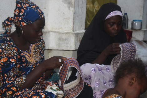 Nigerian women whose husbands were killed by members of the Islamist sect Boko Haram, band together, sewing hats to earn some cash in Maiduguri in northeastern Nigeria. Photo by Chika Oduah. December 16, 2014.