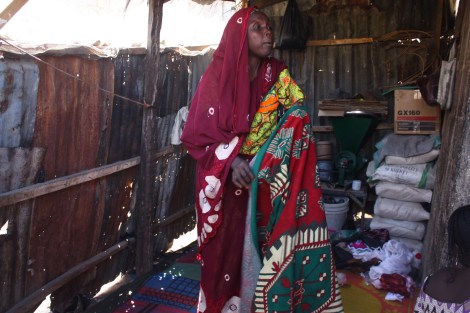 Wasaram Muhammed spreads a mat in the room, calling her children to come for a meal. She says Nigerian soldiers grabbed her husband while he was in a mosque, suspecting him of being a member of the Islamist sect, Boko Haram. He was killed while being held in custody in 2012. Photo by Chika Oduah. Maiduguri, northeastern Nigeria. December 17, 2014.