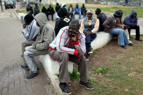epa03124960 African refugees wait for a job offer near the central bus station in southern Tel Aviv, Israel,  27 February 2012. Some 50,000 Africans have entered Israel in recent years, fleeing conflict and poverty in search of safety and opportunity in the relatively prosperous Jewish state. A growing number of African migrants say they were captured, held hostage and tortured by Egyptian smugglers hired to sneak them into Israel.  EPA/ABIR SULTAN