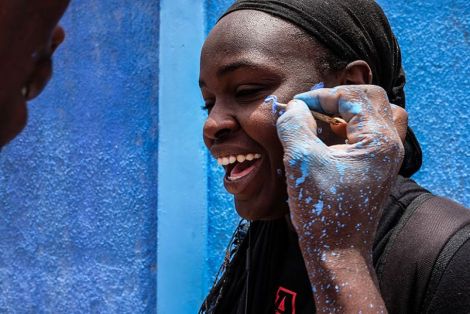 Dieynaba gets her face painted by a fellow graffiti artist. (Photo: Ricci Shryock/ONE)
