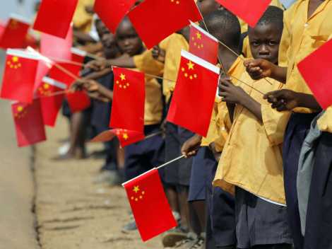 Liberian children hold Chinese flags before the arrival of China's President Hu Jintao in Monrovia February 1, 2007.
