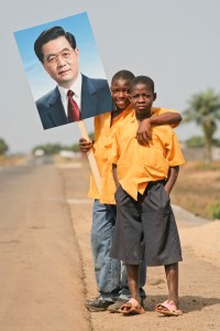 MONROVIA, LIBERIA - FEBRUARY 1, 2007: Liberian kids line the streets of Monrovia, Liberia to celebrate Chinese President Hu visit. Besides rebuilding the National football stadium Chinese aid to the war torn nations is very popular with the locals. Liberia is rich in iron ore, timber, rubber and other resources which are desired by China. (Photo by Christopher Herwig / Aurora)