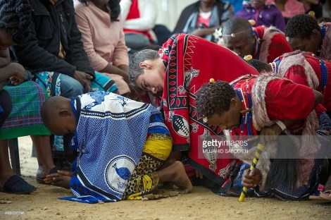 Twelve-year-old South African Kyle Todd (C) performs during his initiation ceremony to become a Sangoma or traditional healer at a traditional healer school on November 14, 2015, in Pretoria, South Africa. South African traditional healers are practitioners of traditional African medicine in Southern Africa. They fulfill different social and political roles in the community, including divination, healing physical, emotional and spiritual illnesses, directing birth or death rituals, finding lost cattle, protecting warriors, counteracting witches, and narrating the history, cosmology, and myths of their tradition. AFP PHOTO / MUJAHID SAFODIEN