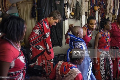 Twelve-year-old South African Kyle Todd (2nd L) gets ready for his initiation ceremony to become a Sangoma or traditional healer at a traditional healer school on November 14, 2015, in Pretoria, South Africa. South African traditional healers are practitioners of traditional African medicine in Southern Africa. They fulfill different social and political roles in the community, including divination, healing physical, emotional and spiritual illnesses, directing birth or death rituals, finding lost cattle, protecting warriors, counteracting witches, and narrating the history, cosmology, and myths of their tradition. AFP PHOTO / MUJAHID SAFODIEN
