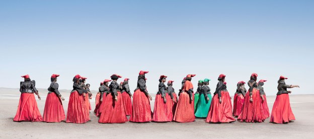 A photo graph of modern-day Herero women. Herero women marching. In 2011 Jim Naughten spent four months photographing the Herero tribe of Namibia. The London-based photographer drove thousands of miles through the desert, meeting and negotiating with people, camping and continuously cleaning the dust out of his camera equipment. Photo: Jim Naughten