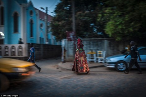 A man dressed up as a Voodoo Idol walks the streets before the start of the annual festival at the weekend. AFP/ Getty Images 