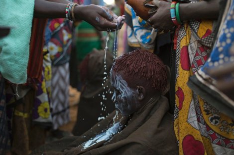 A Pokot girl is smeared with a white paint to show she has undergone the rite of passage of circumcision. Photo by Siegfried Modola