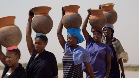 Women carry calabashes. A scene from the film, ZIN’NAARIYÂ!, The Wedding Ring